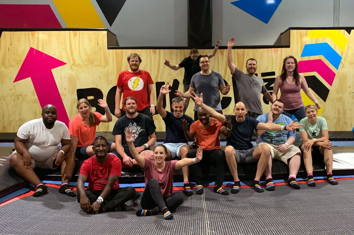 The Codeo team jumping together outdoors